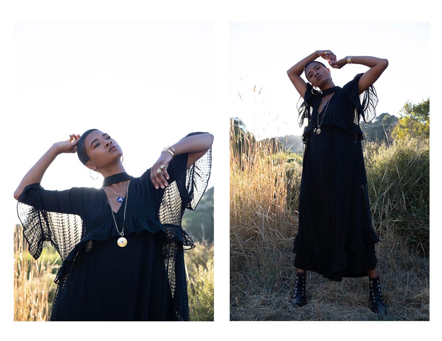 Woman in nature with arms raised wearing rings, earrings, pendant necklaces and bracelets for Good Juju Collection