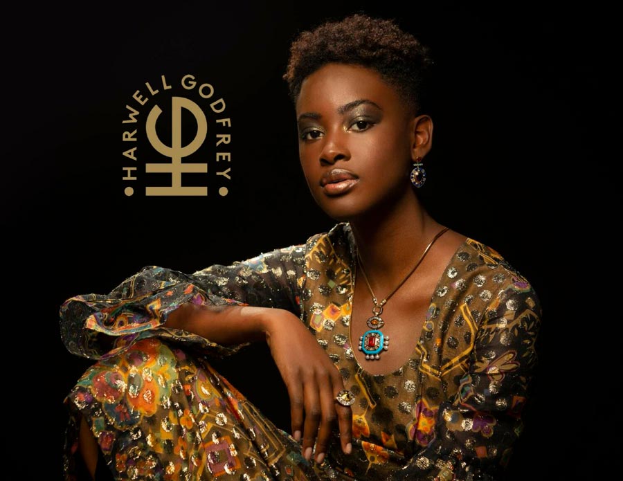 Woman looking at camera wearing earrings, pendant and ring for Cleopatra's Vault Lookbook